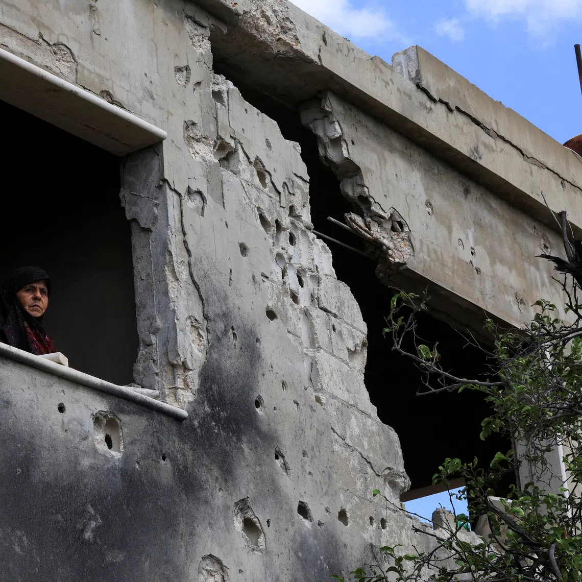 Mariam al-Yaghi ,67, Lebanese resident from West Zawtar, stands in her damaged house in southern Lebanon, October 1, 2026. REUTERS/Mohamed Azakir