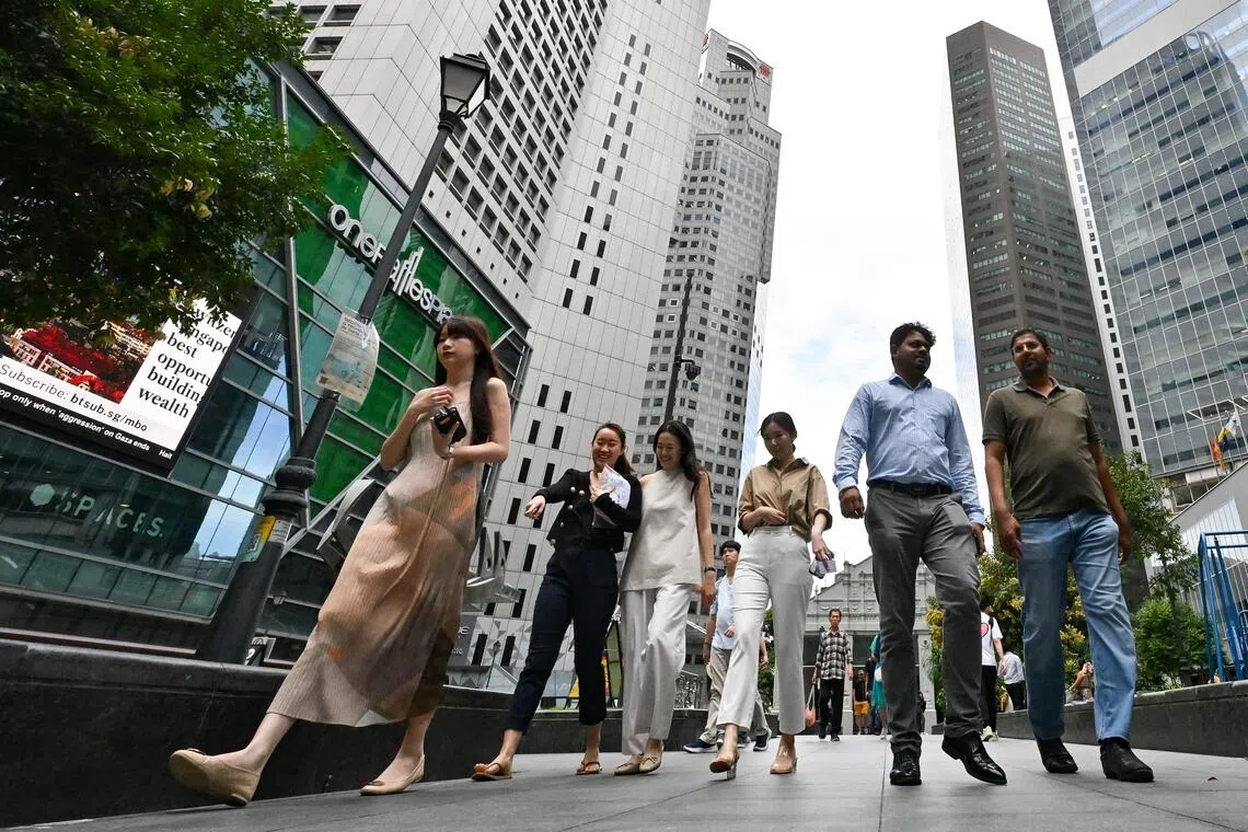 Office workers walking at Raffles Place Park within the heart of Singapore's financial centre in the CBD area on Feb 14, 2024. employment, manpower, labour