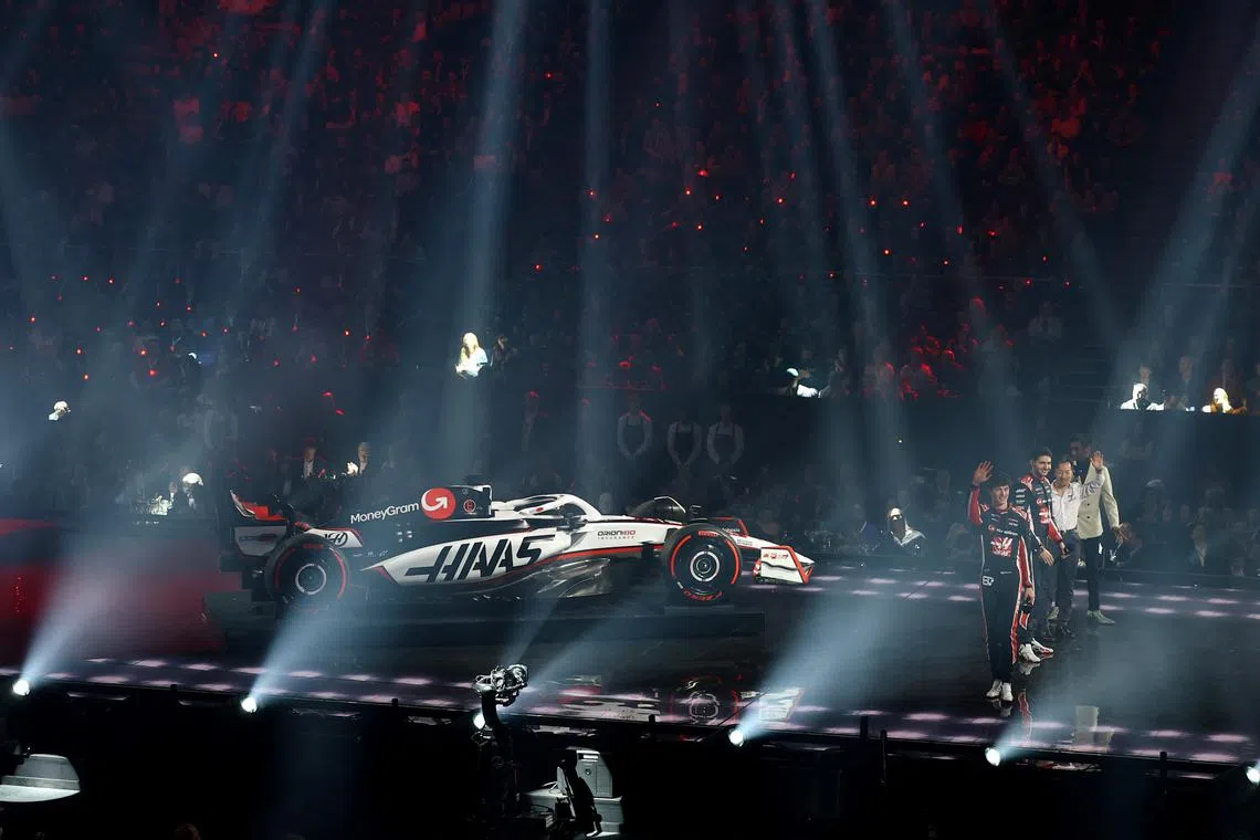 FILE PHOTO: Formula One F1 - F1 75 Live Season Launch - The O2, London, Britain - February 18, 2025 Haas team principal Ayao Komatsu with drivers Oliver Bearman and Esteban Ocon in front of their car during the launch REUTERS/Andrew Boyers/File Photo