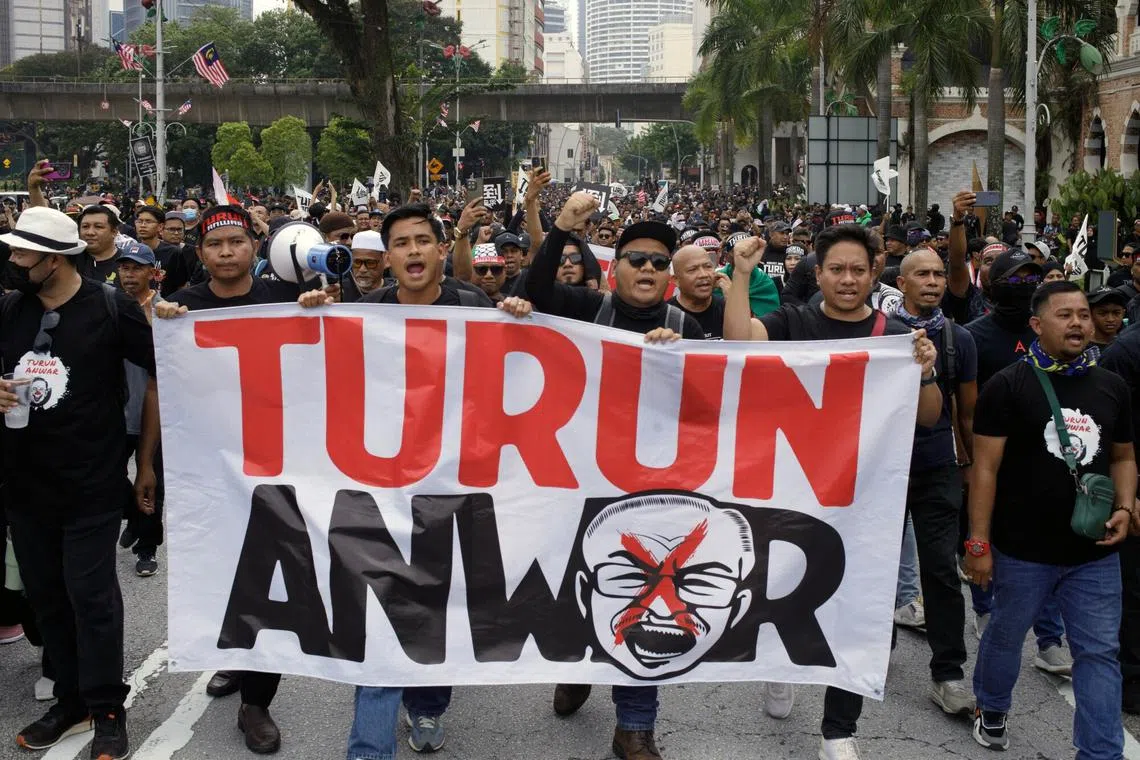 Protesters hold a banner during a demonstration calling for the resignation of Malaysian Prime Minister Anwar Ibrahim in Kuala Lumpur, Malaysia, on July 26.