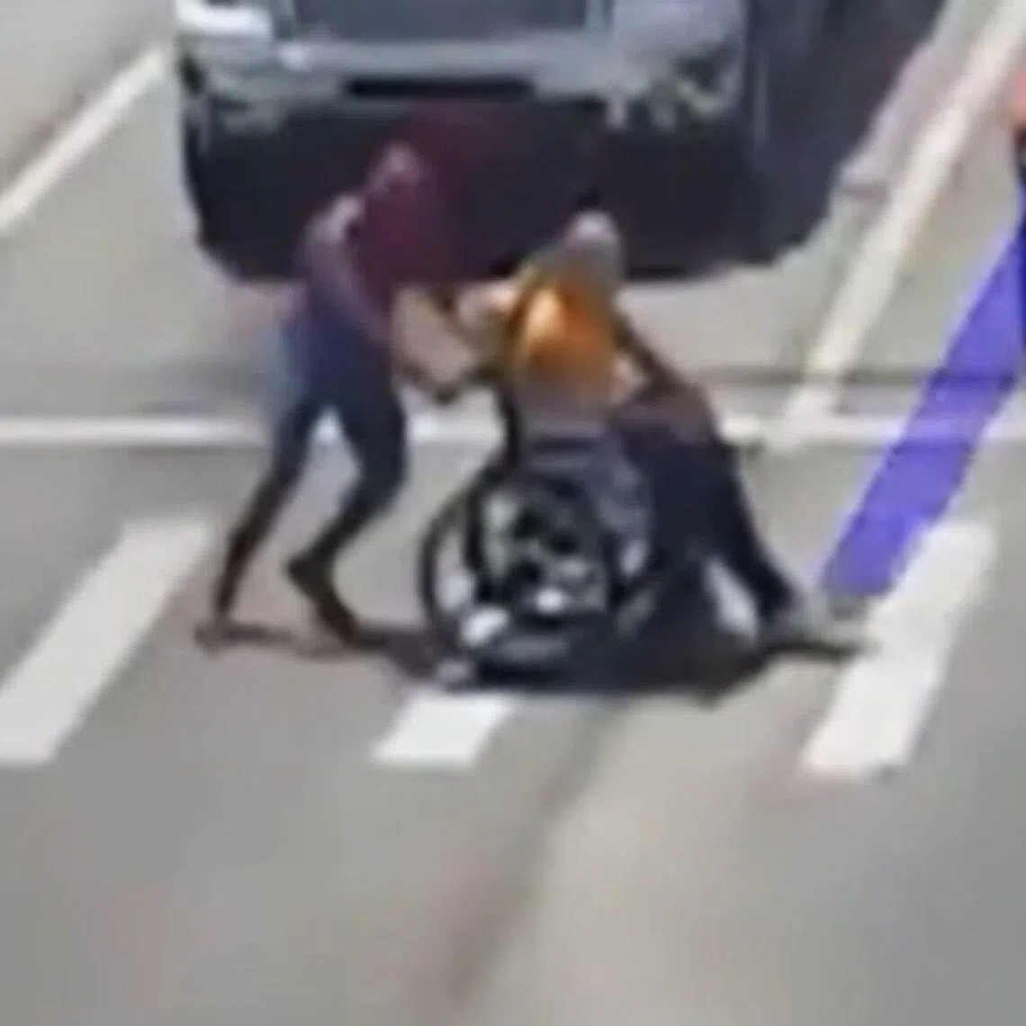 In a Spider-Man costume, Christopher Hellenthal pushed another man in a wheelchair who was struggling to cross the road.