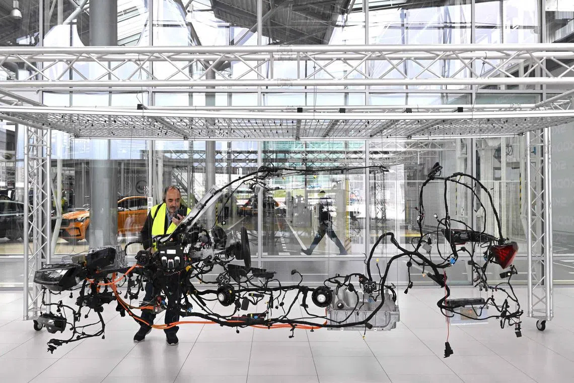 A journalist taking photo of the model of the electrical installation of the new Skoda Octavia car during the presentation of the new brand identity of the Czech automobile manufacturer Skoda in Mlada Boleslav, Czech Republic on April 25, 2023.
