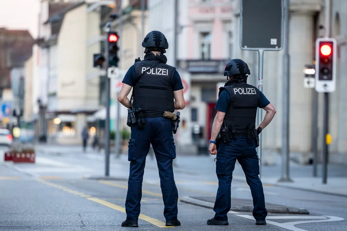 Swiss police officers patrol a street in downtown Aarau after reports of a shooting on Aug 30.