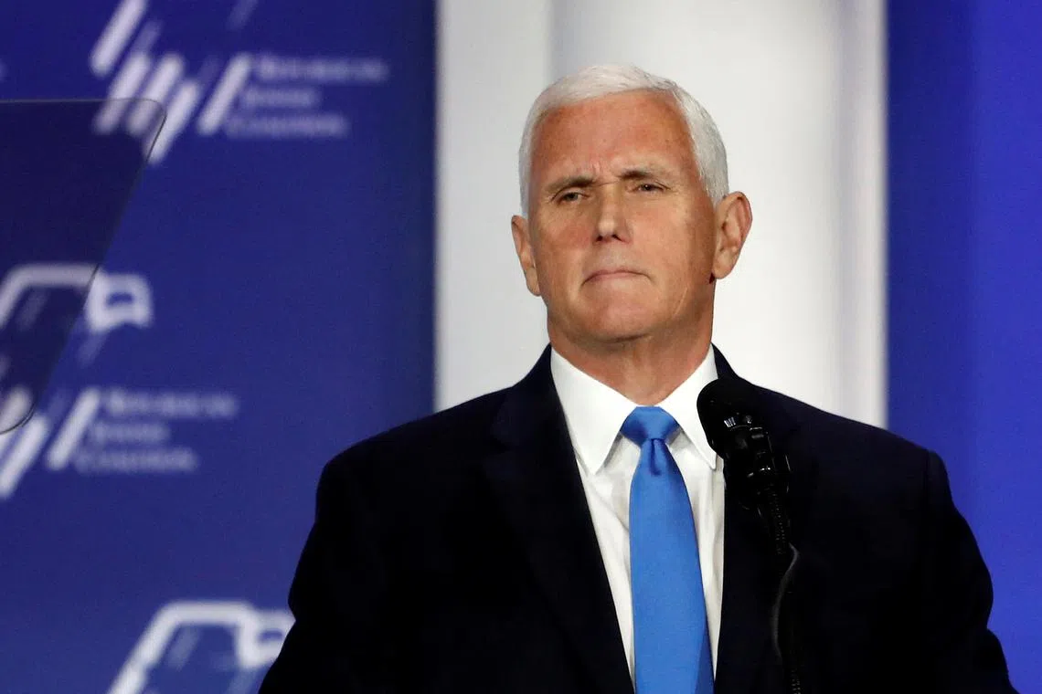 FILE PHOTO: Former U.S. Vice President Mike Pence stands at the podium after announcing he will discontinue his presidential campaign, during the Republican Jewish Coalition Annual Leadership Summit in Las Vegas, Nevada, U.S. October 28, 2023. REUTERS/Steve Marcus/File Photo