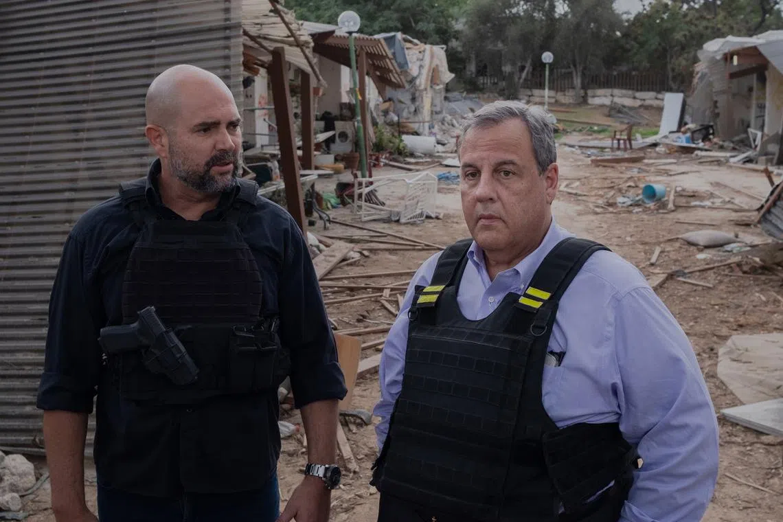 Former New Jersey Governor Chris Christie (right) visits Kfar Aza, an Israeli kibbutz near the border with Gaza, on Nov 12, 2023.