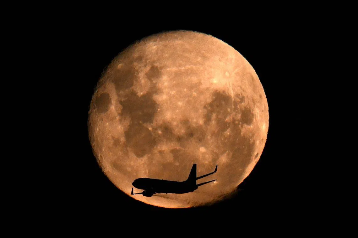 An aircraft operated by Brazil’s airline GOL flying past the waning gibbous moon over Buenos Aires, on March 4, 2026.