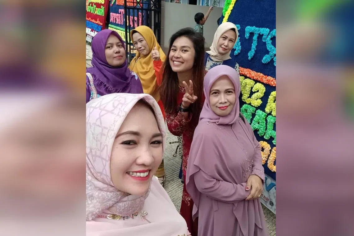 Ms Eileen Soh (in the middle, dressed in red) with wedding guests in May 2023 in the city of Sungai Penuh, Jambi province, in Indonesia. 