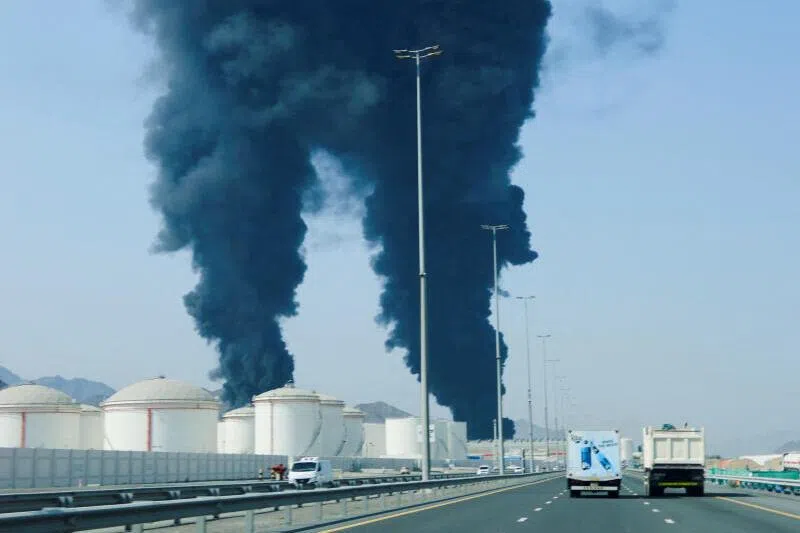 Smoke rising in the Fujairah oil industry zone, caused by debris after interception of a drone by air defences, on March 14, in Fujairah, United Arab Emirates.