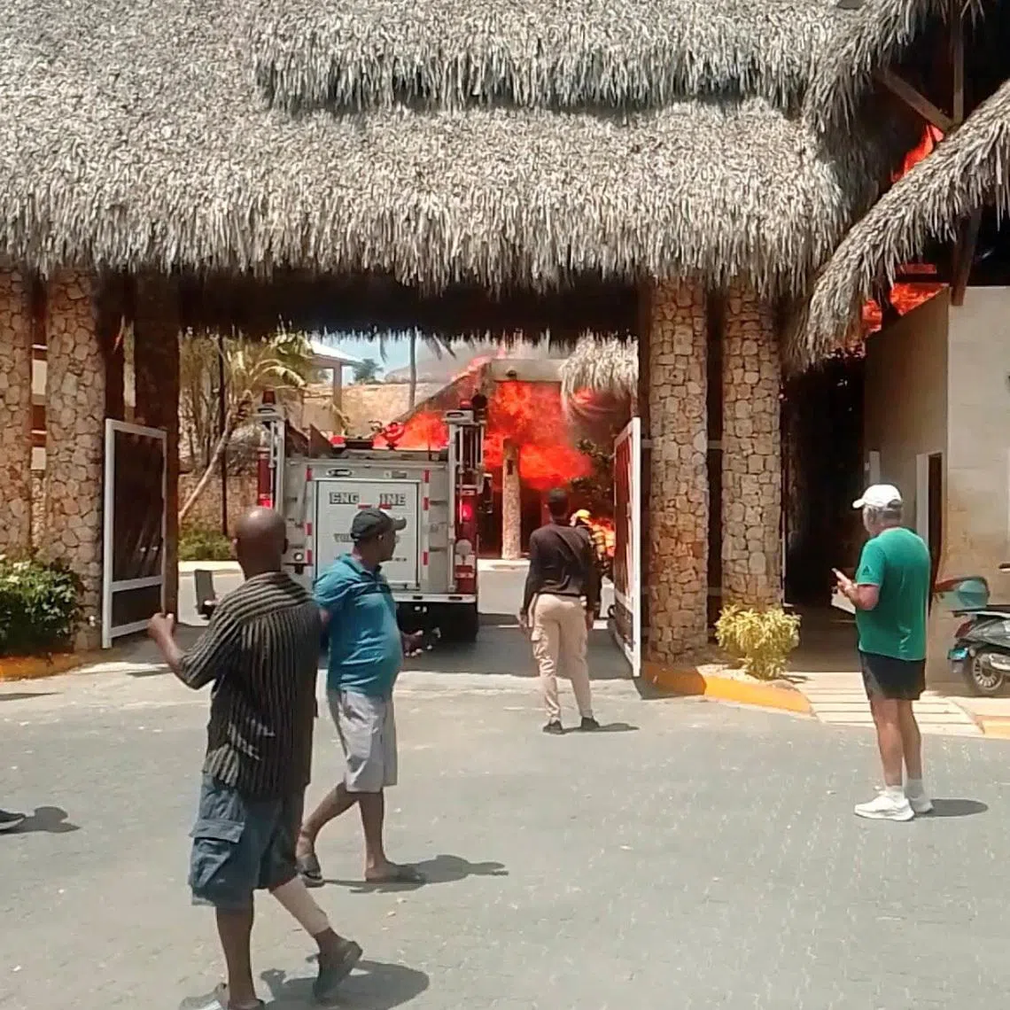People looking at the fire at Viva Dominicus resort in Bayahibe, Dominican Republic, on June 19.