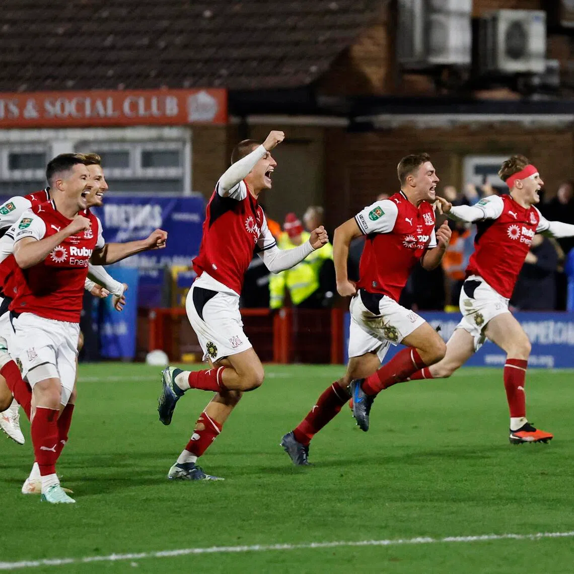 Fleetwood Town’s Finley Potter and teammates celebrate beating Arsenal in the Oct 27 League Cup penalty shootout.