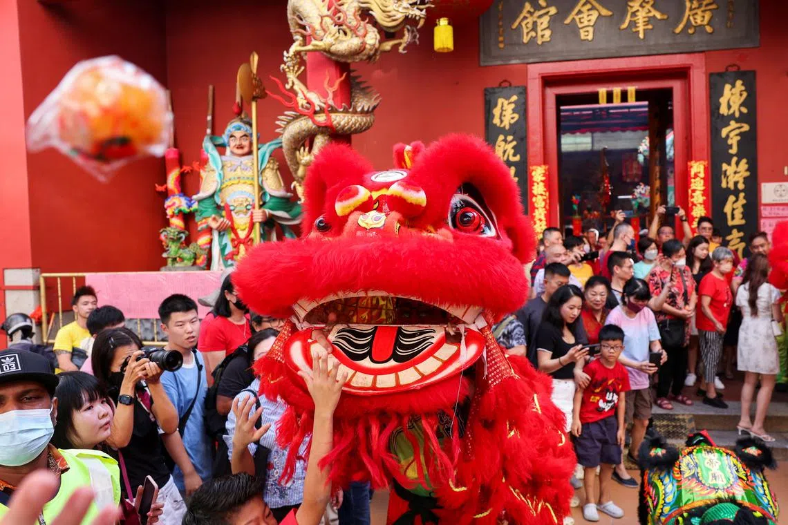 Worshippers watching the lion dance performance on the first day of Lunar New Year of the Dragon at Taoist temple in Kuala Lumpur, Malaysia, Feb 10, 2024. 