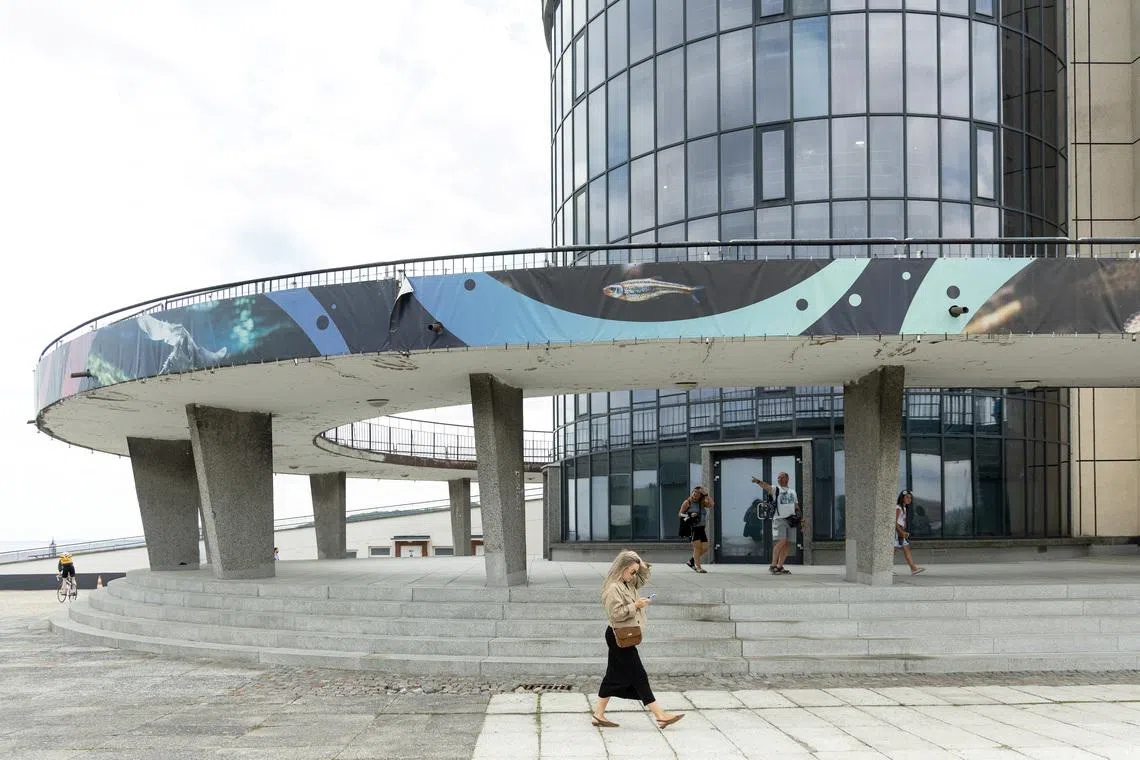 People walk in front of the Gdynia Aquarium building, a site on the Gdynia Modernism Trail, in Gdynia, Poland, July 25, 2026. REUTERS/Lukasz Glowala
