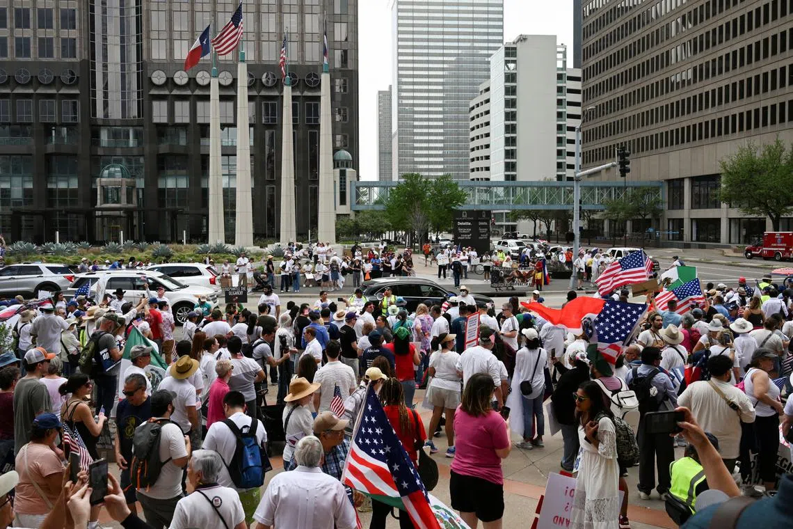 FILE PHOTO: Demonstrators gather outside of the National Shrine Cathedral of Our Lady of Guadalupe before walking through the streets of downtown during the \"Mega Marcha\", calling for immigration reform, in Dallas, Texas, U.S. March 30, 2025. REUTERS/Jeremy Lock/File Photo