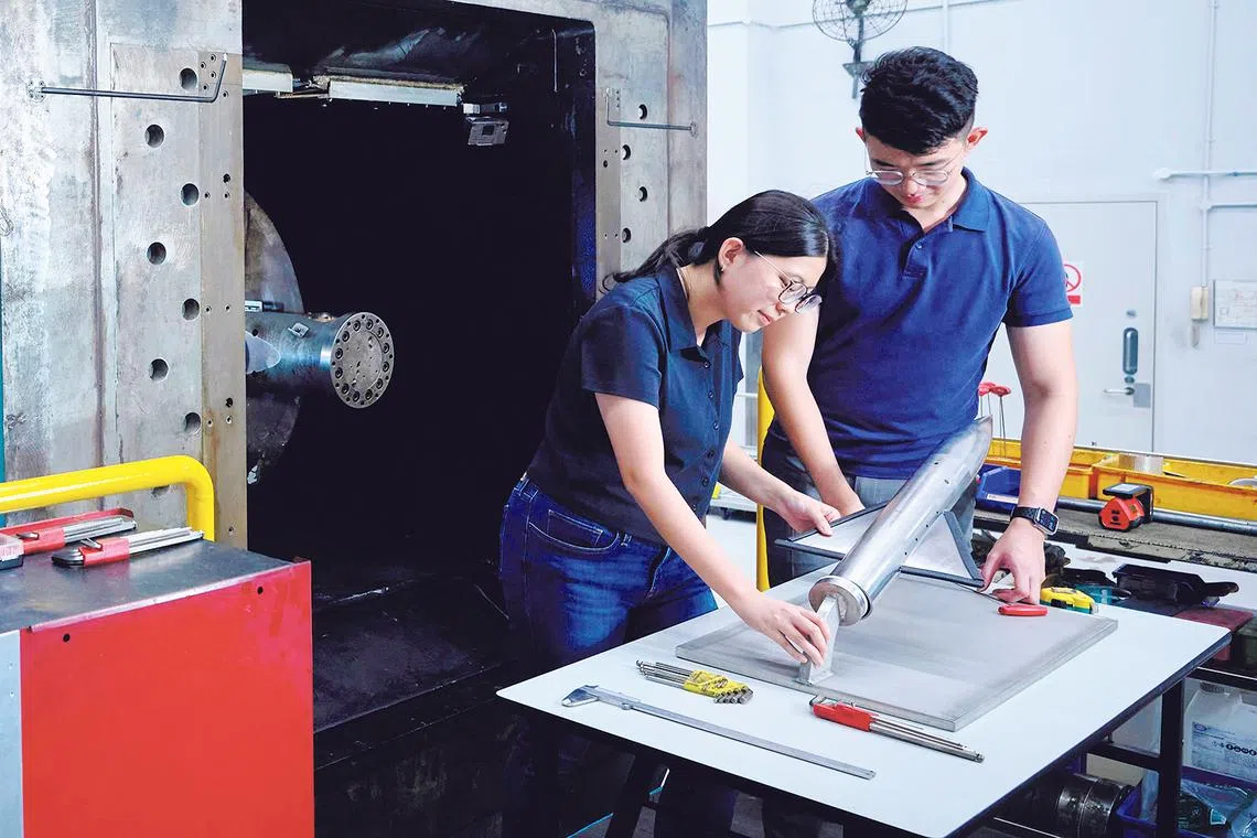 singapore best employers 2026 dso national laboratories engineer jolene kwek (left) preparing for an aerodynamics test, highlighting the hands-on work central to her on-the-job learning