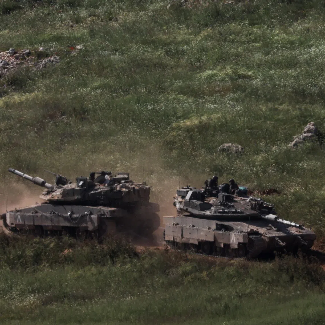 Tanks and an armoured vehicle drive in Lebanon, as seen from the Israeli side of the Israel-Lebanon border, in northern Israel, April 25, 2026.