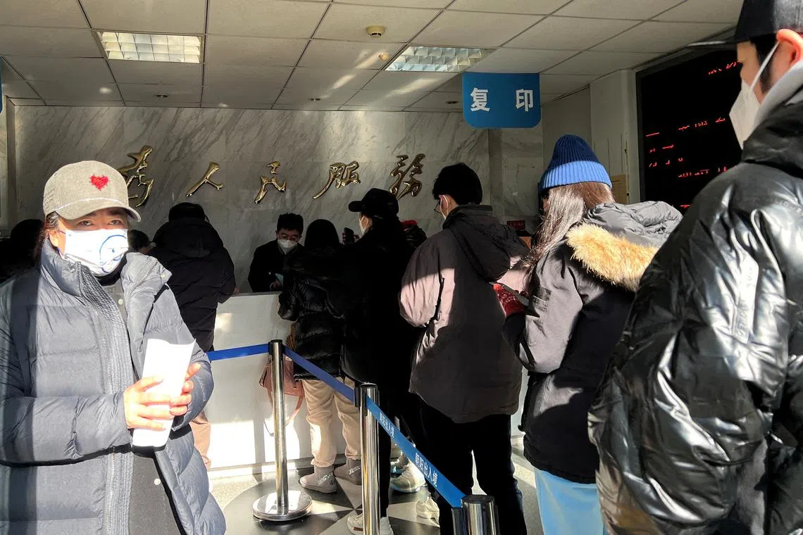 People line up at a government office which provides services including renewing passports to go to Hong Kong, Macau and Taiwan.