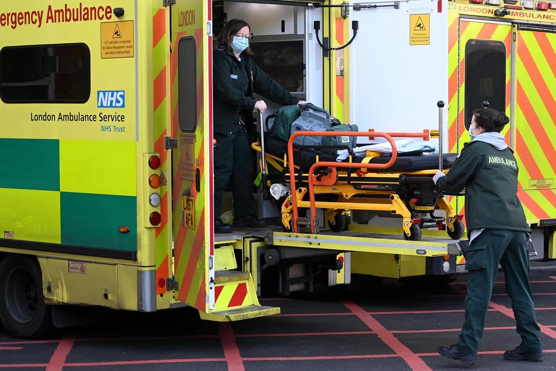 epa10353682 NHS ambulances staff outside a hospital in London, Britain, 07 December 2022. More than 10,000 NHS ambulance staff from nine NHS hospital trusts in England and Wales will walk out on 21 December in a dispute over pay, GMB trade union announced.  EPA-EFE/ANDY RAIN