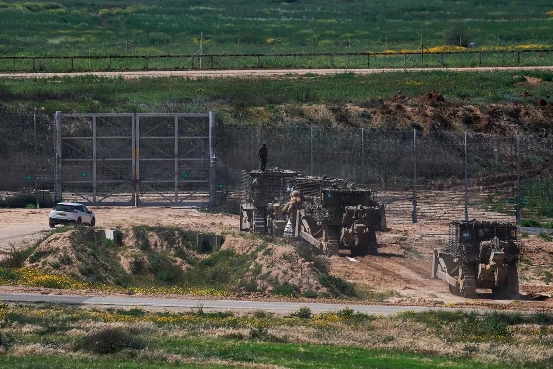 A teddy bear is attached to an Israeli military bulldozer near Israel's border with Gaza, amid the ongoing conflict between Israel and the Palestinian Islamist group Hamas, as seen from southern Israel, March 21, 2024. REUTERS/Ammar Awad