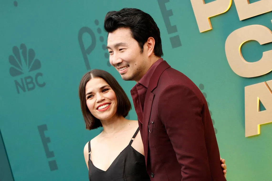 Canadian actor Simu Liu and US actress America Ferrera arrive for the 2024 People's Choice awards at the Barker Hangar in Santa Monica, California, February 18, 2024. (Photo by Michael TRAN / AFP)