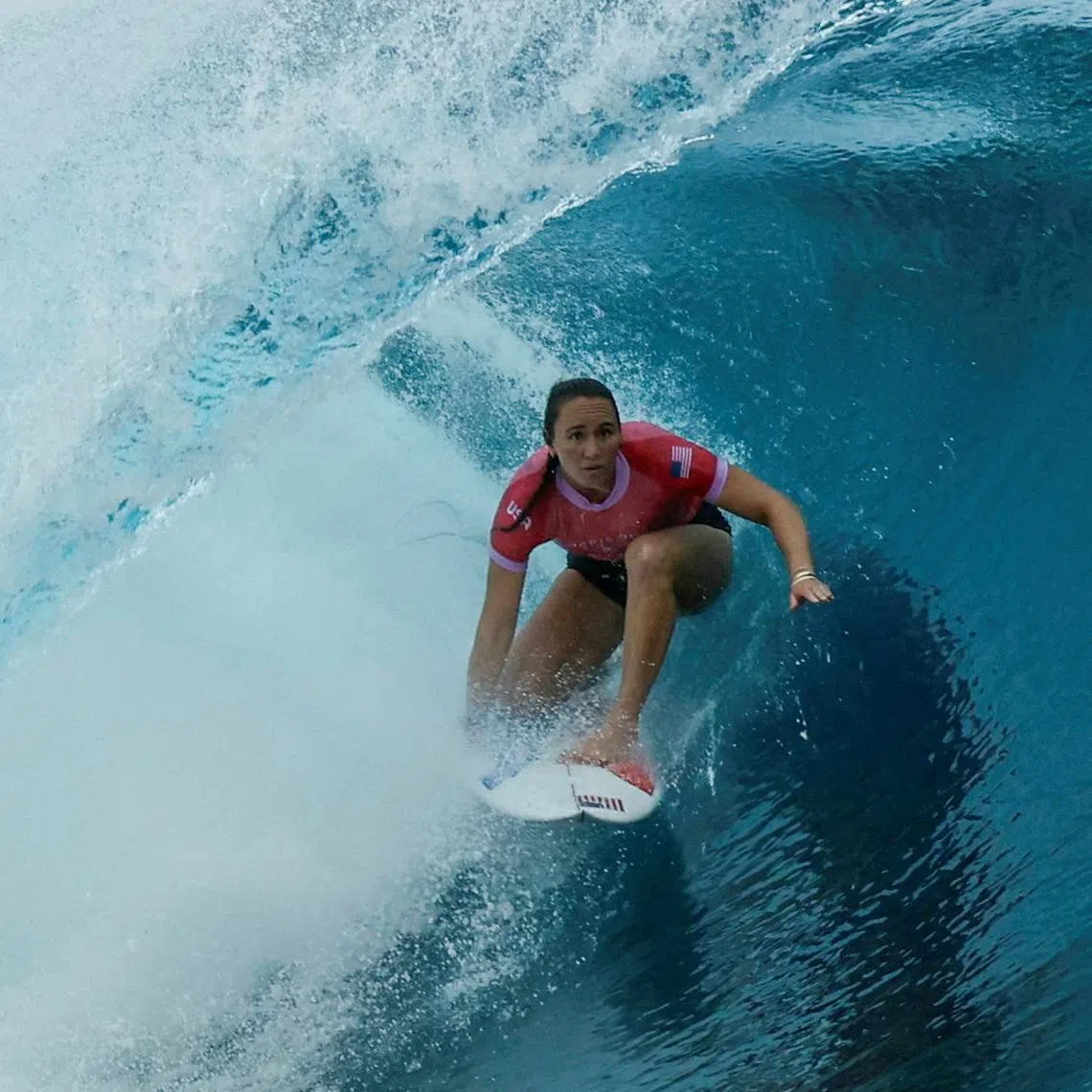 FILE PHOTO: Paris 2024 Olympics - Surfing - Women's Round 1 - Heat 8 - Teahupo'o, Tahiti, French Polynesia - July 27, 2024. Carissa Moore of United States rides in the barrel. Ben Thouard/Pool via REUTERS/File Photo