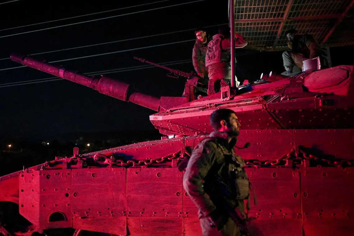 Israeli soldiers gather near a military vehicle after returning from Lebanon, following a ceasefire between Israel and Iran-backed group Hezbollah, near Kiryat Shmona and Israel's border with Lebanon in northern Israel, December 11, 2024. REUTERS/Rami Shlush ISRAEL OUT. NO COMMERCIAL OR EDITORIAL SALES IN ISRAEL     TPX IMAGES OF THE DAY     