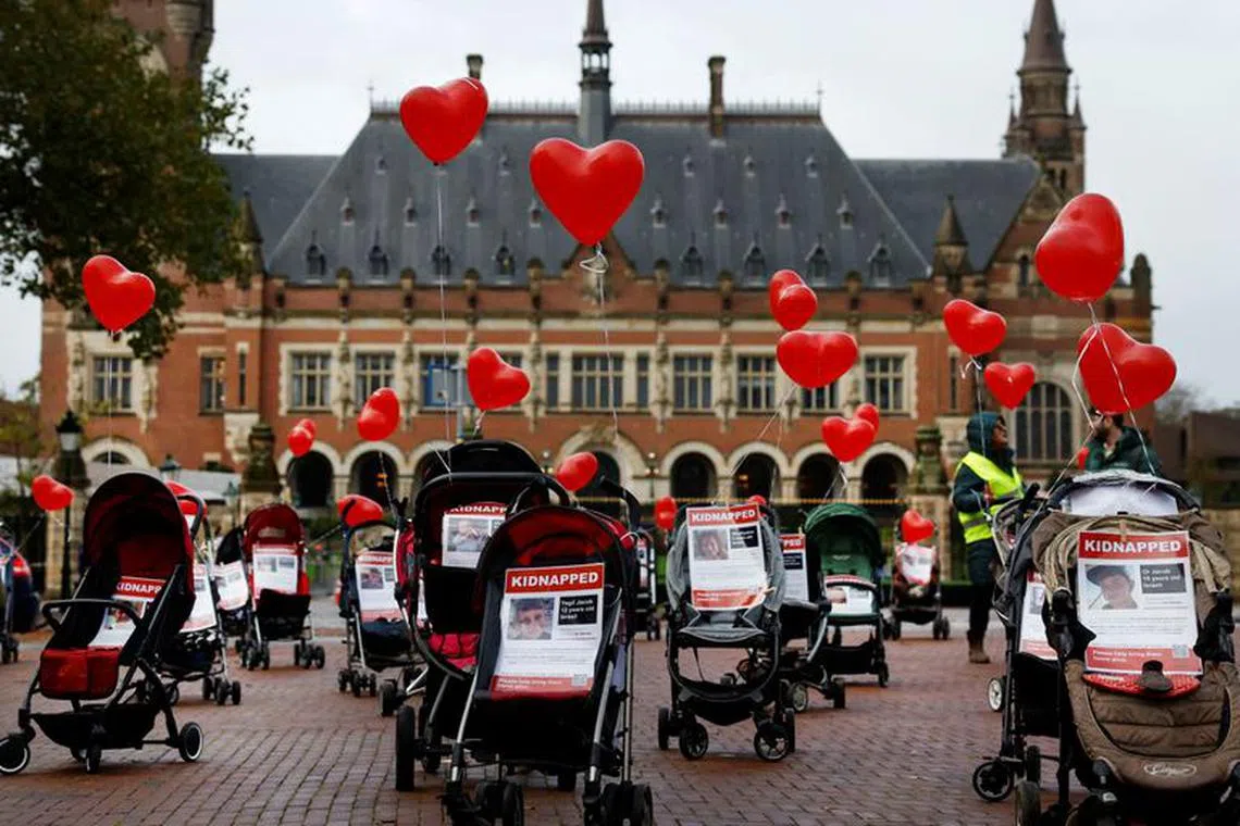 FILE PHOTO: Strollers with pictures of kidnapped children are placed by protesters in front of the seat of the United Nations World Court in The Hague to protest the abduction of Israeli children by Hamas on October 7, in The Hague, Netherlands November 3, 2023. REUTERS/Piroschka van de Wouw/File Photo