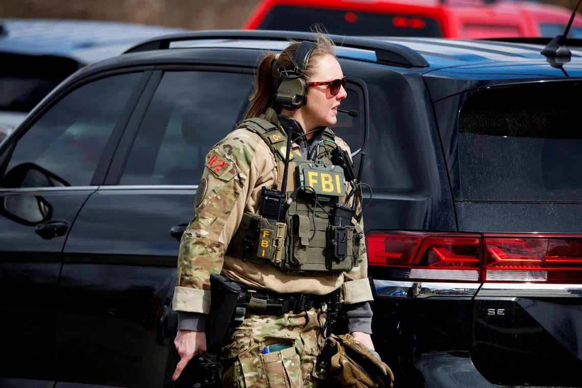 An FBI member works on the site after the Michigan State Police reported an active shooting incident at the Temple Israel Synagogue in West Bloomfield, Michigan, U.S., March 12, 2026. REUTERS/Rebecca Cook