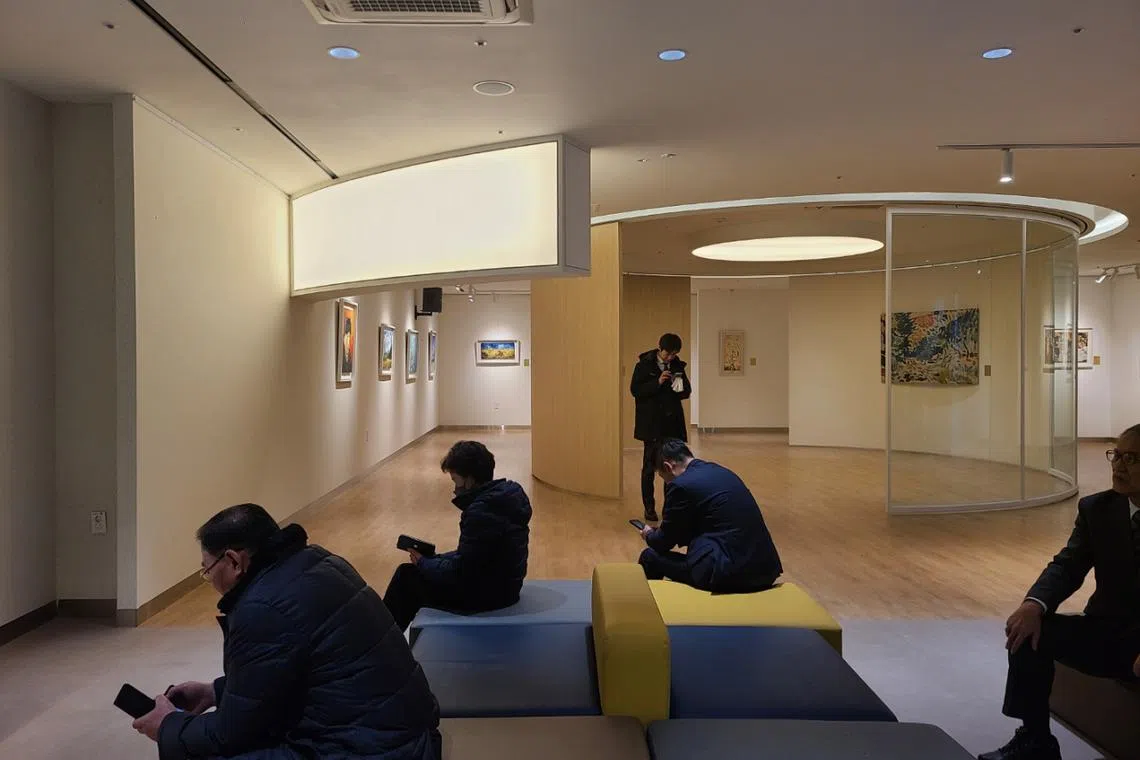 Visitors sit in the "In-yeon" Gallery at Seoul Memorial Park.