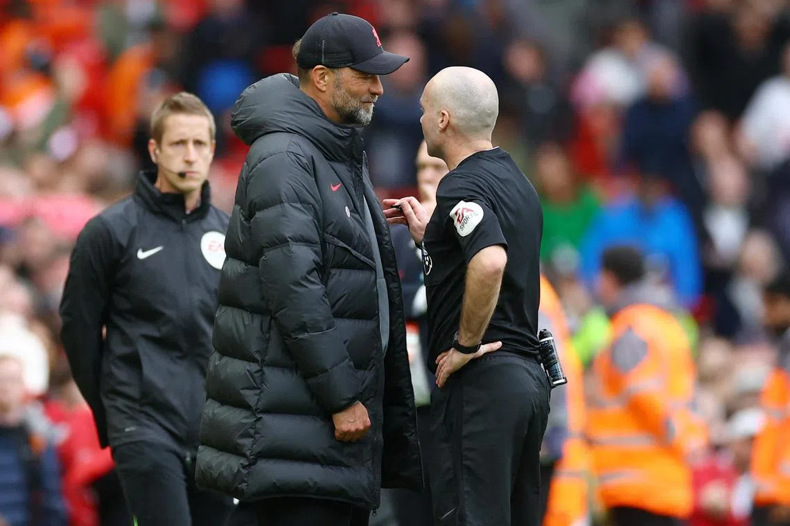 Soccer Football - Premier League - Liverpool v Tottenham Hotspur - Anfield, Liverpool, Britain - April 30, 2023
Referee Paul Tierney talks to Liverpool manager Juergen Klopp REUTERS/Carl Recine EDITORIAL USE ONLY. No use with unauthorized audio, video, data, fixture lists, club/league logos or 'live' services. Online in-match use limited to 75 images, no video emulation. No use in betting, games or single club	/league/player publications.  Please contact your account representative for further details.