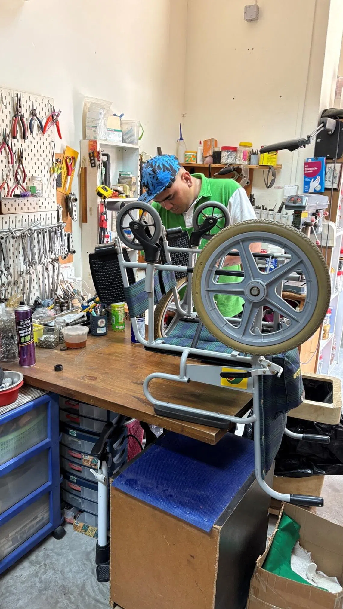 staff at kampung senang repairing wheelchair at the charity’s mobility aids service and training centre in jurong east