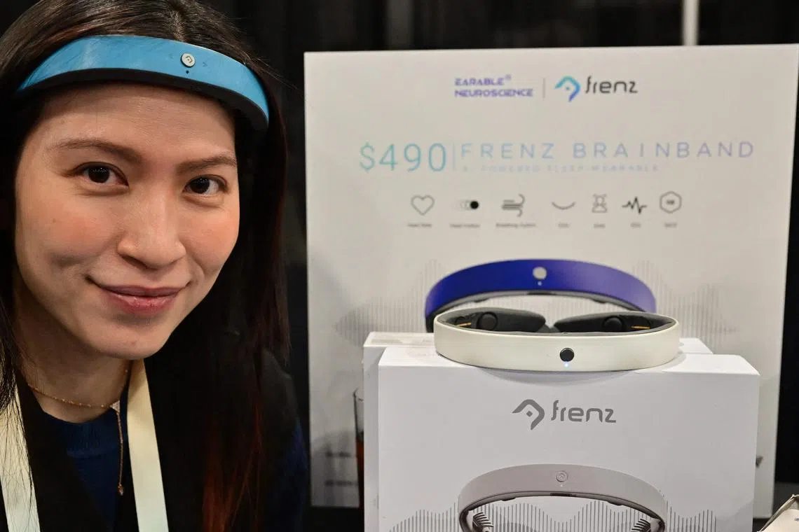 Ms Kim Doan models how a Brainband from Earable neuroscience works.