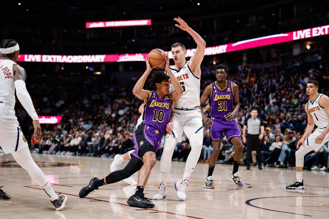 Los Angeles Lakers guard Max Christie drives to the net against Denver Nuggets centre Nikola Jokic in the first quarter at Ball Arena.