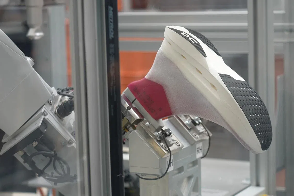 Paris 2024 Olympics - Athletics - Running brand On launches spray-on marathon shoe in bid for Paris spotlight - Paris, France - July 25, 2024  The running brand On made its latest move in the supershoe race on the eve of the Paris Olympics, unveiling a marathon shoe produced by a robotic arm spraying material onto a mold to create a sock-like upper, with no laces. REUTERS/Joyce Zhou