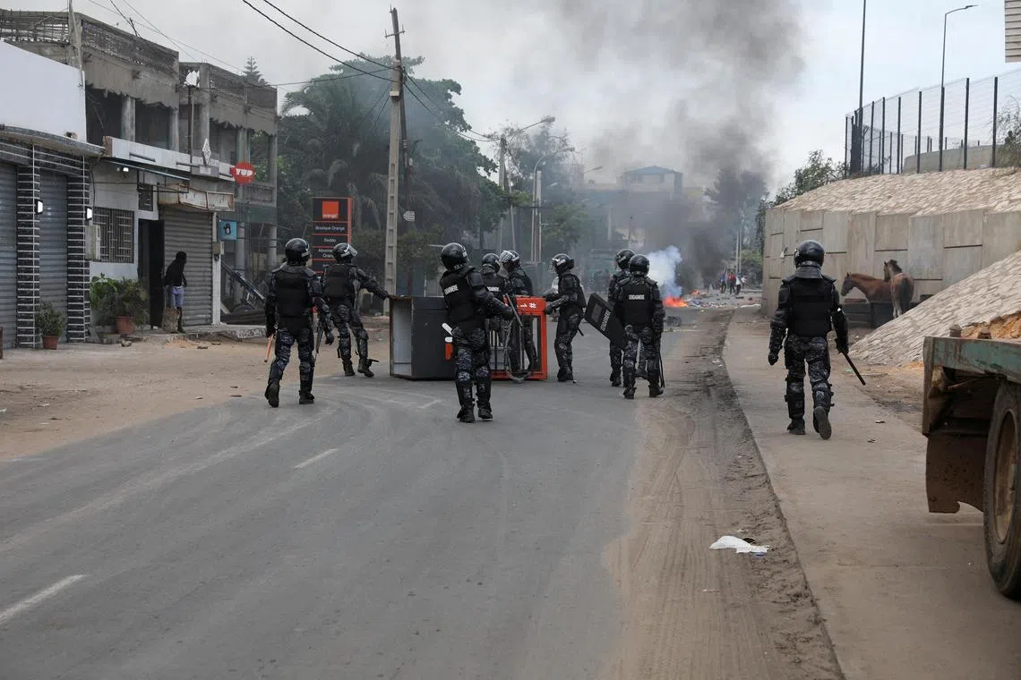 Gendarmes remove a Kiosk overturned by protestors to block the road at Yarakh after opposition leader Ousmane Sonko has been detained, in Dakar, Senegal, July 31, 2023. REUTERS/Ngouda Dione