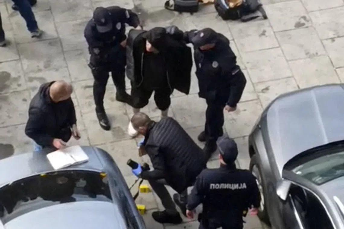 Serbian police officers detain a man in front of the Parliament in Belgrade, Serbia, in this screen grab obtained from a handout video released October 22, 2025. Marina Jankulovic/Handout via REUTERS  THIS IMAGE HAS BEEN SUPPLIED BY A THIRD PARTY. MANDATORY CREDIT. NO RESALES. NO ARCHIVES.