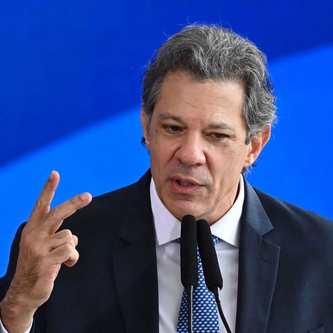 Brazil's Finance Minister Fernando Haddad gestures as he speaks during the signing ceremony of the new Income Tax Law at the Planalto Palace in Brasilia, on November 26, 2025. (Photo by Evaristo Sa / AFP)