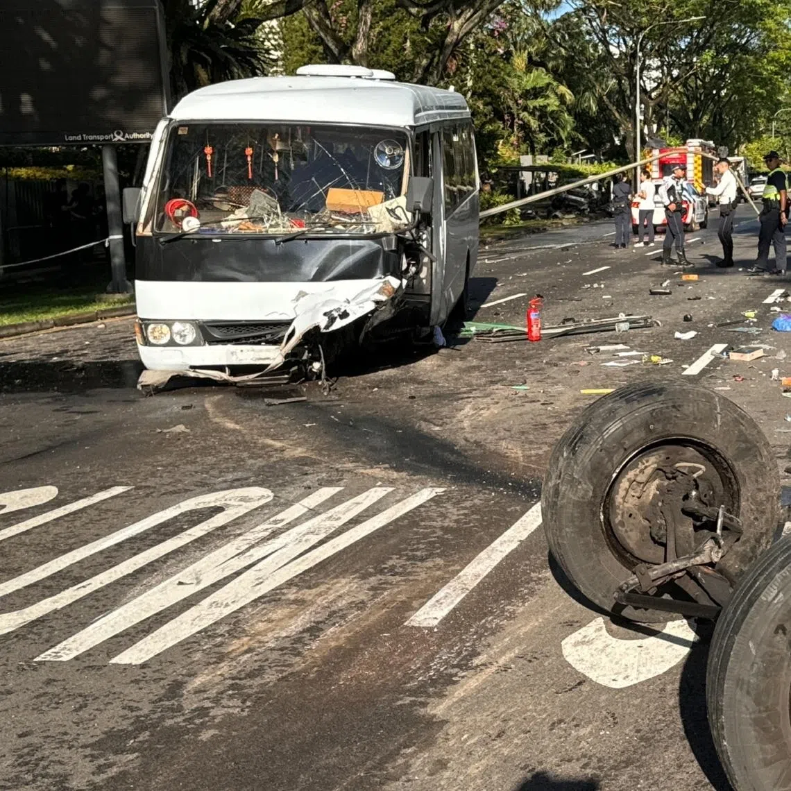 School supplies such as files, pieces of paper and lunch boxes are seen strewn across the the road.