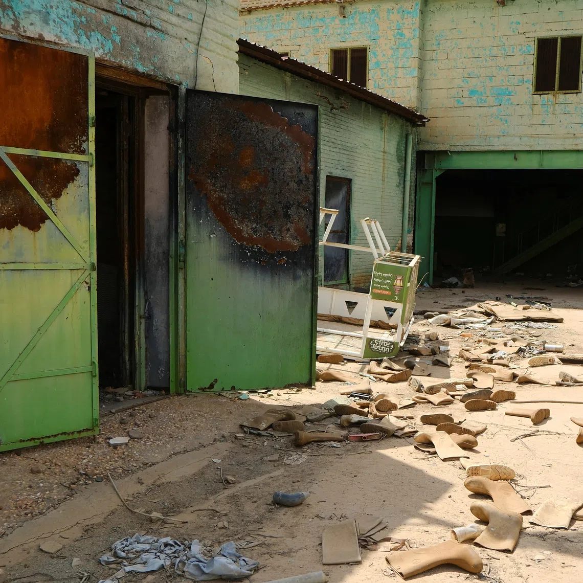 Safety shoes are scattered in a destroyed factory in Omdurman, Sudan October 14, 2025. REUTERS/El Tayeb Siddig