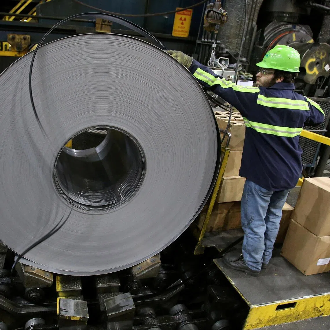 A finished steel coil is secured by a worker at a US steel mill in Farrell, Pennsylvania.