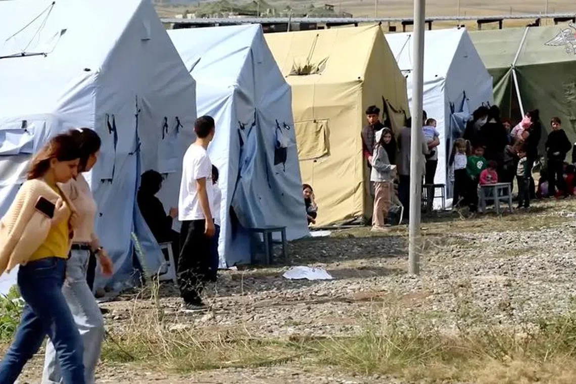 FILE PHOTO: A view shows civilians evacuated by Russian peacekeepers following Azerbaijani armed forces' offensive operation in Nagorno-Karabakh, a region inhabited by ethnic Armenians, in an unknown location in Nagorno-Karabakh, in this still image from video published September 21, 2023. Russian Defence Ministry/Handout via REUTERS/File Photo