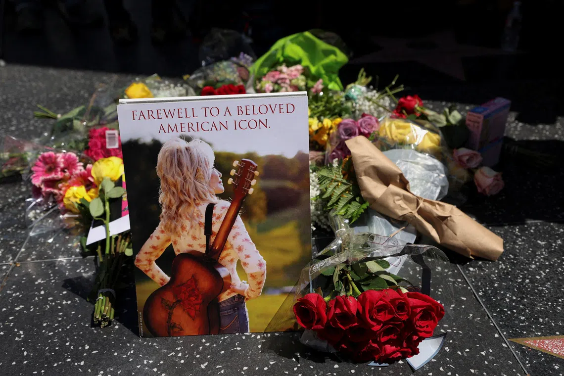 Flowers lie at the star of Dolly Parton on the Hollywood Walk of Fame after it was announced that the country music icon died aged 80 on Aug 25.