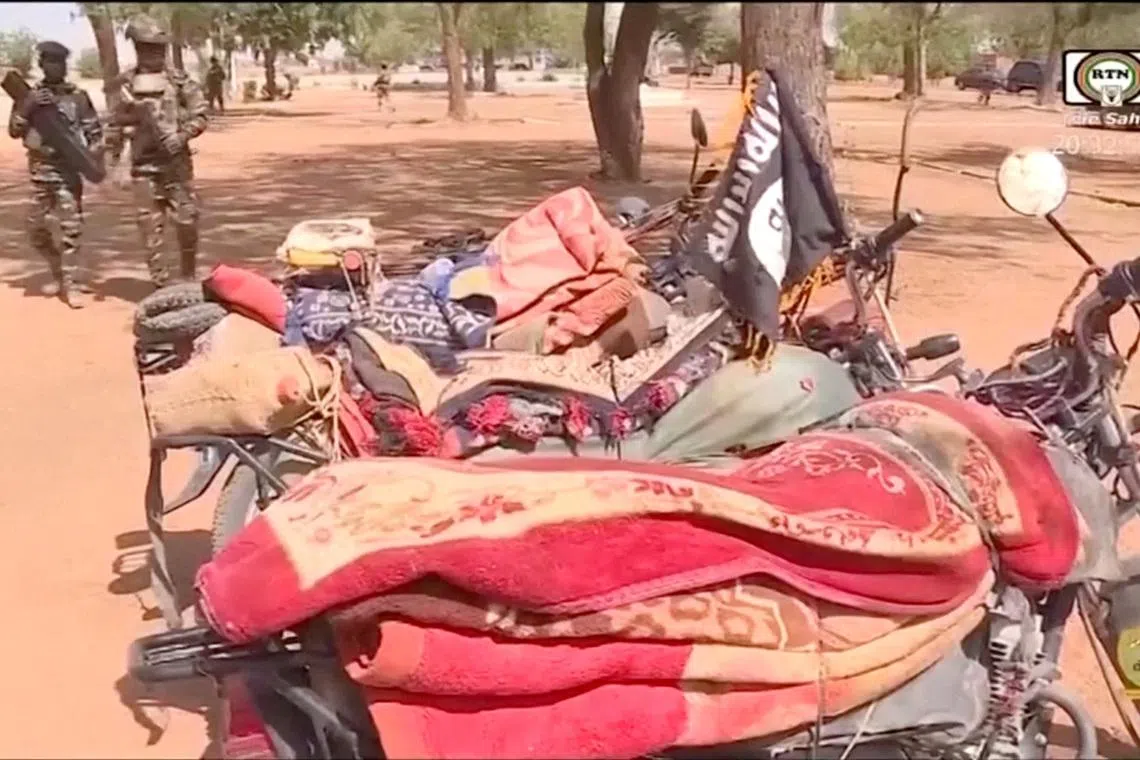 Members of the Nigerien army walk near the motorcycles seized from the attackers, following an attack on Niamey International Airport, in Niamey, Niger January 29, 2026, in this screengrab from a video. ORTN/Reuters TV/Handout via REUTERS
