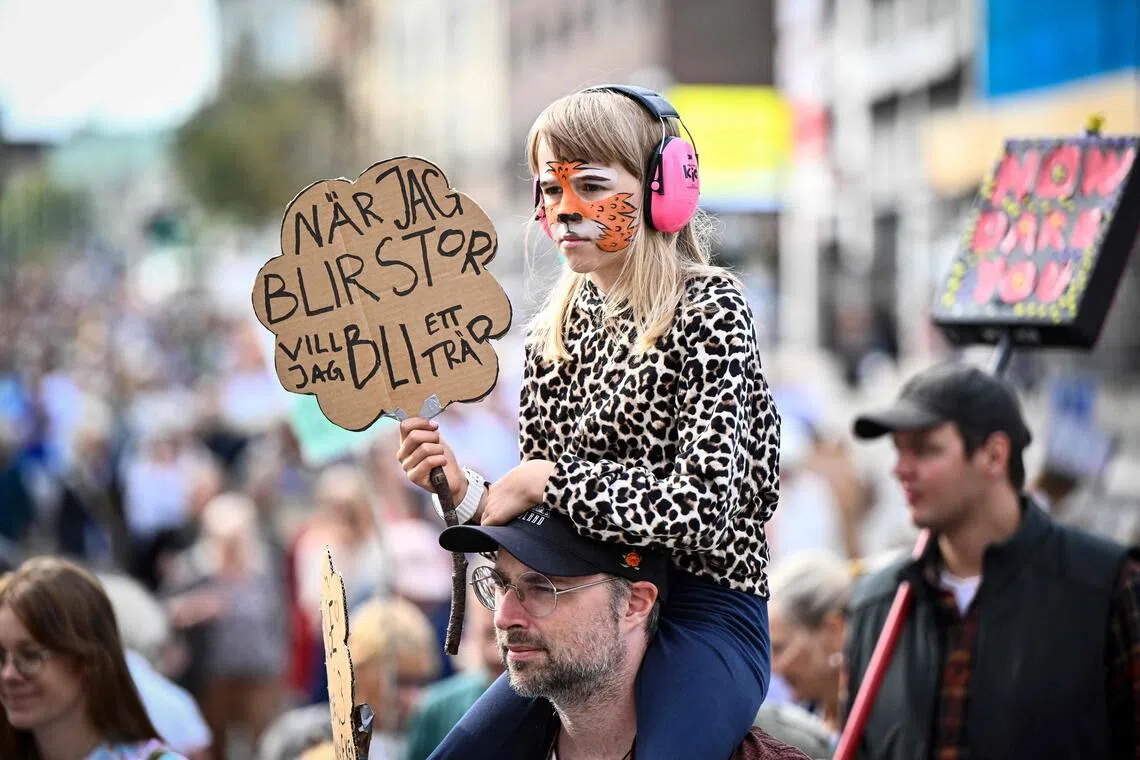Protesters take part in a climate demonstration organised by the Swedish Society for Nature Conservation together with Rebel Moms, Rebel Dads and Researchers Desk in central Stockholm, Sweden, on Aug 23.