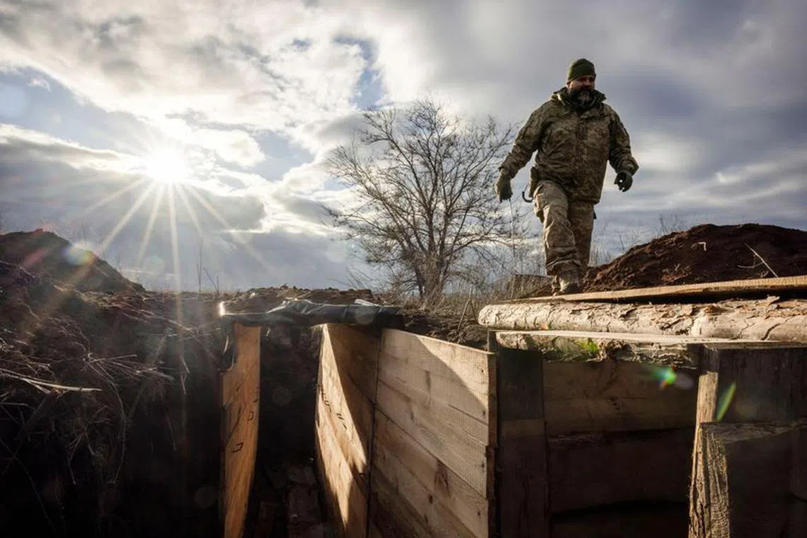 Ukrainian military engineer with the callsign Lynx inspects a freshly dug trench that his unit built as part of a system of new fortifications near the front lines outside Kupiansk, amid Russia’s attack on Ukraine, December 28, 2023.  REUTERS/Thomas Peter/file photo