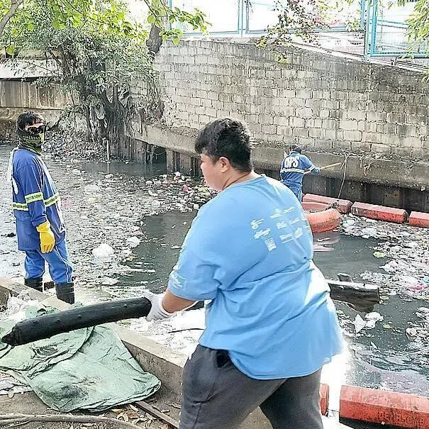 Local officials conducting a clean-up operation near the Pasig River in Manila in February 2026.