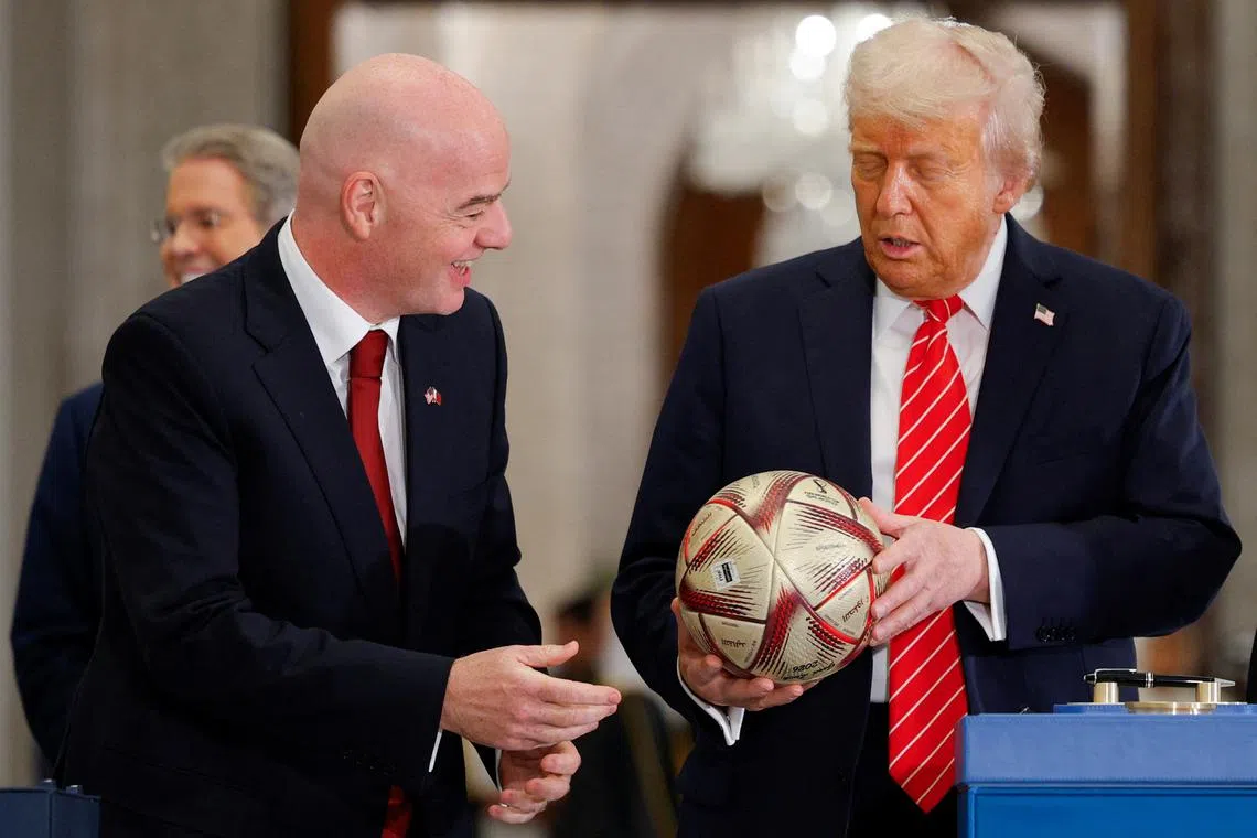 U.S. President Donald Trump holds a soccer ball as he attends an event with Qatar's Emir Tamim bin Hamad Al Thani (not pictured) and FIFA President Gianni Infantino, at Lusail Palace in Lusail, Qatar, May 14, 2025. REUTERS/Brian Snyder