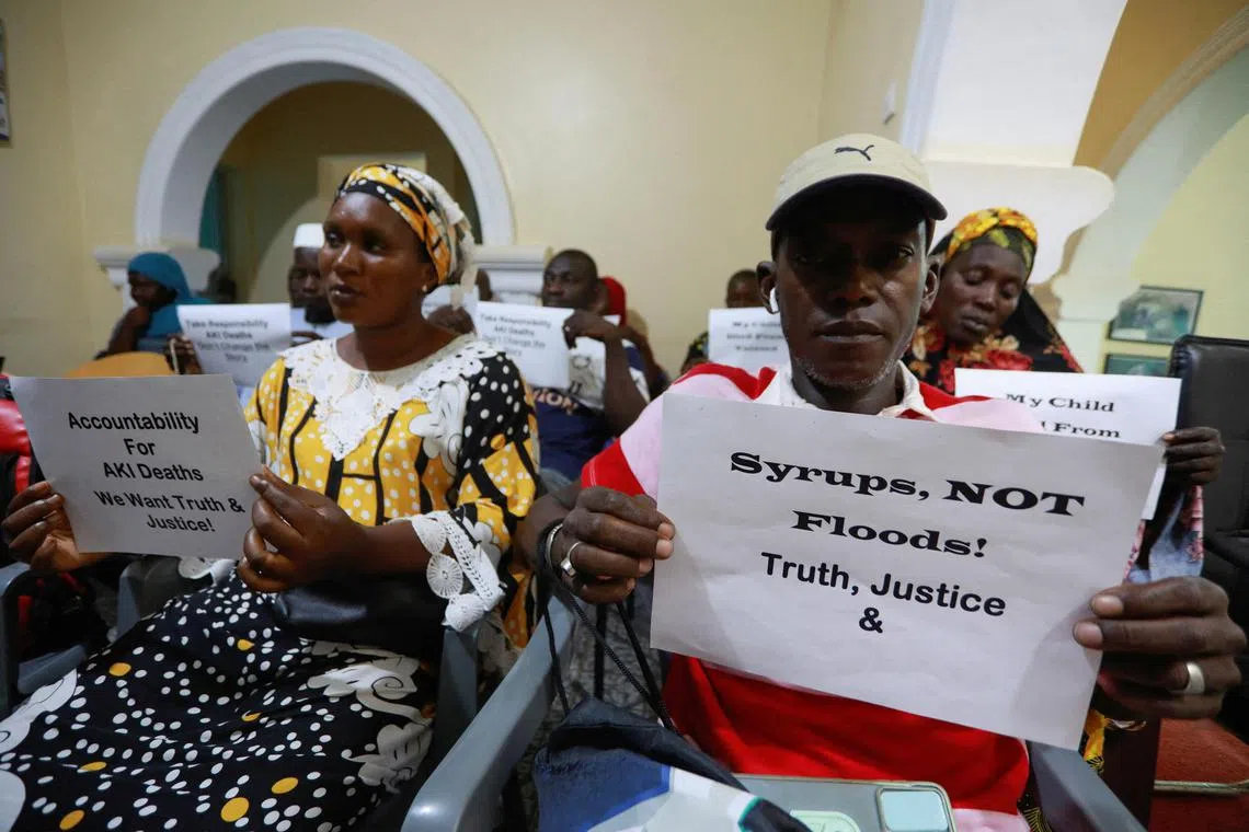 A 2022 photo shows a news conference in Gambia, at which grieving parents held up signs calling for justice for the deaths of their children.