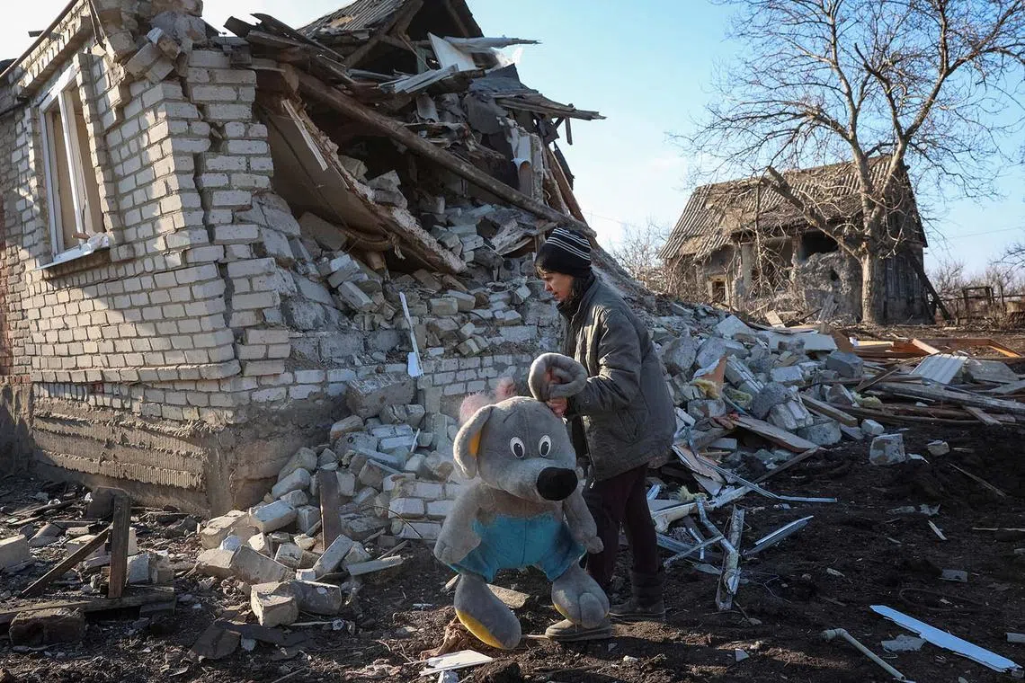 Natalia, a resident, collecting her granddaughter's toys that were scattered around her home hit by a Russian air strike, amid Russia's attack on Ukraine, in the town of Kostiantynivka, Donetsk region, Ukraine, Feb 9, 2025.