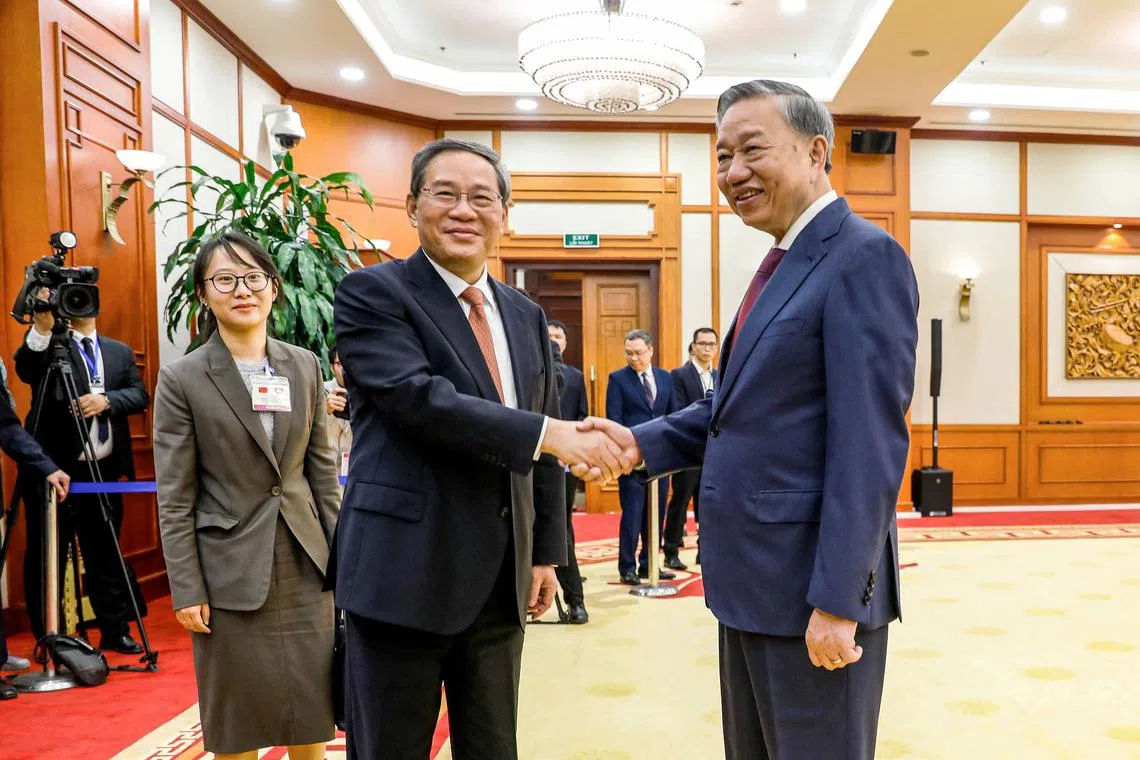 Chinese Premier Li Qiang (centre) meets Vietnam's President To Lam in Hanoi on Oct 12.
