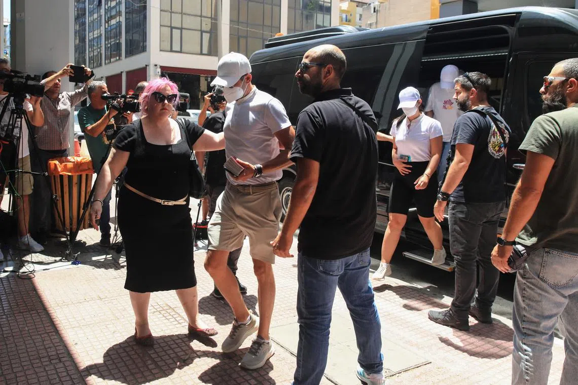 Crew members of a yacht, who allegedly caused a forest fire on the island of Hydra after launching fireworks from the vessel, are transferred to the prosecutor's office at the courthouse of Piraeus, Greece, June 23, 2024. Giannis Panagopoulos/Eurokinissi via REUTERS